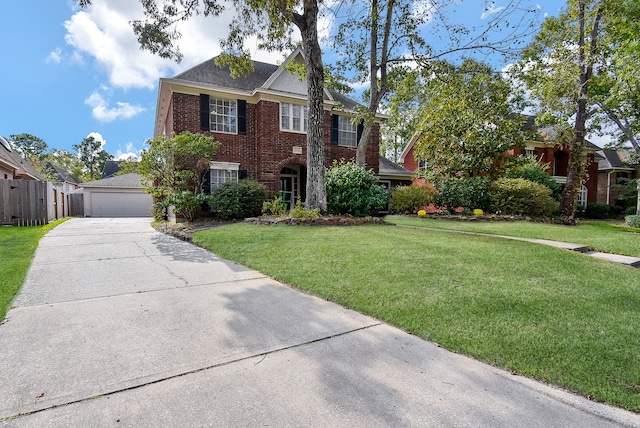 colonial house featuring a front lawn and a garage