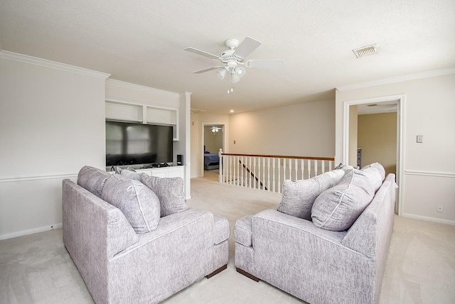 living room with light carpet, baseboards, visible vents, a ceiling fan, and ornamental molding