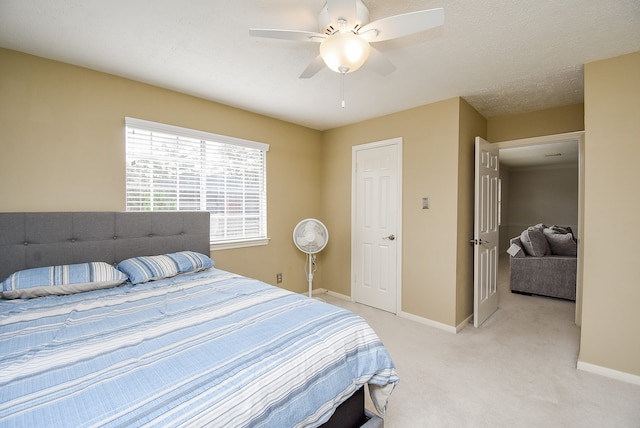 bedroom featuring light colored carpet and ceiling fan