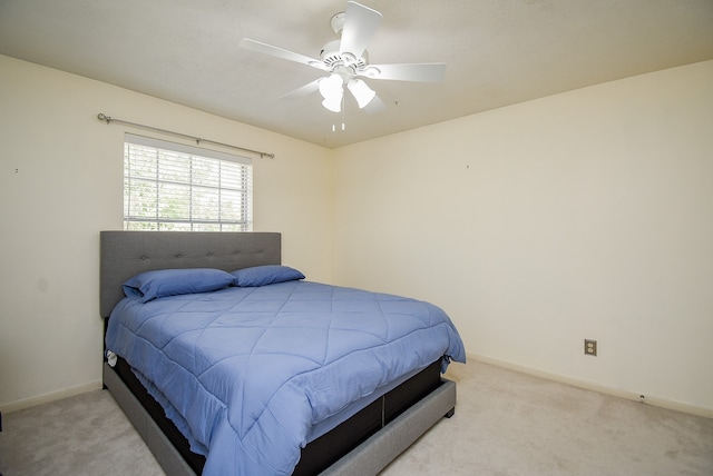 bedroom with ceiling fan and light colored carpet