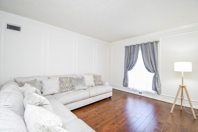 living room featuring crown molding and dark hardwood / wood-style flooring