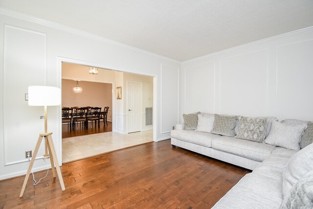 living room with ornamental molding and dark wood-type flooring