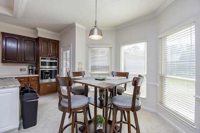 dining room featuring crown molding, baseboards, and light tile patterned floors