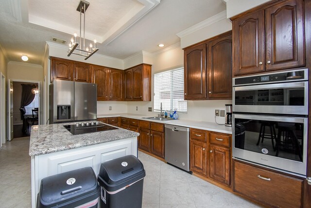 kitchen with sink, stainless steel appliances, pendant lighting, ornamental molding, and a chandelier