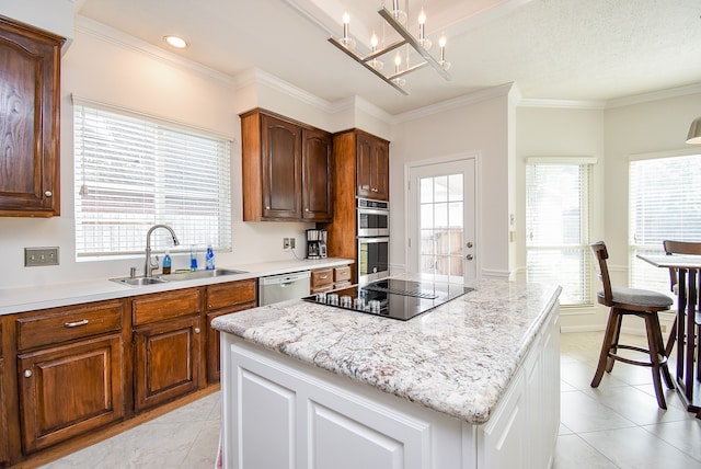 kitchen with sink, crown molding, a center island, light tile patterned floors, and appliances with stainless steel finishes