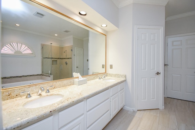 full bath featuring crown molding, visible vents, a sink, and a shower stall