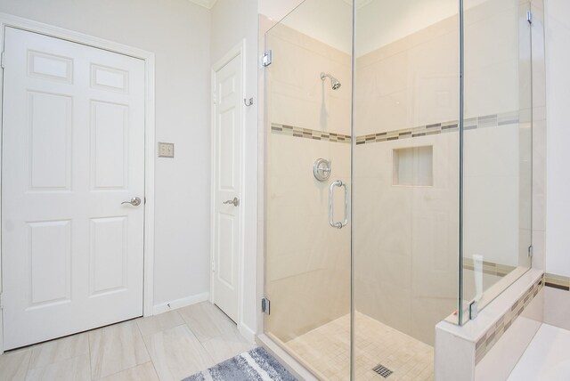 bathroom featuring a shower with door