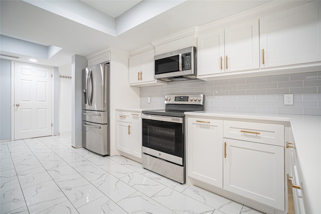 kitchen with stainless steel appliances, white cabinets, and decorative backsplash