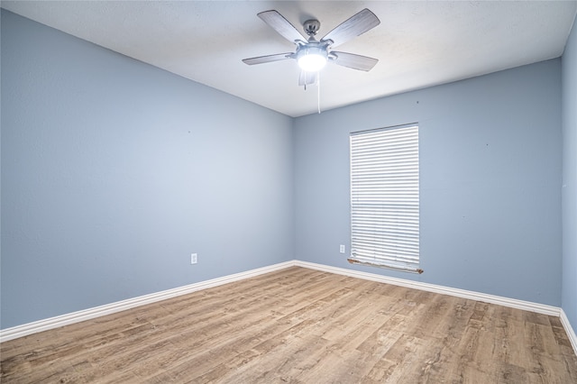 spare room with ceiling fan and wood-type flooring