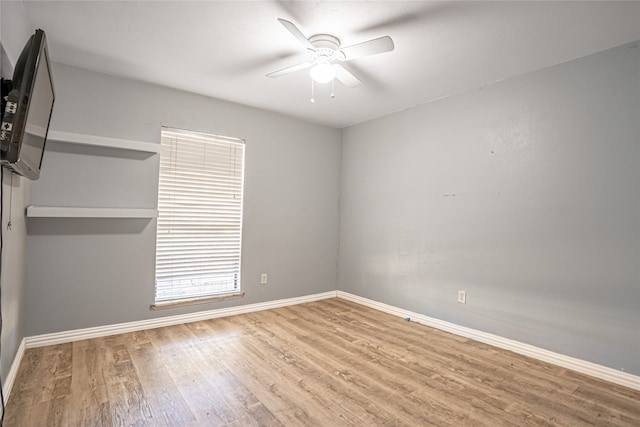 spare room with ceiling fan and wood-type flooring