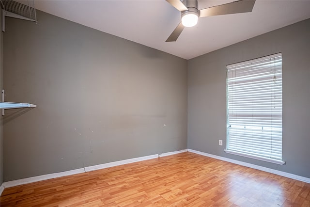 unfurnished room featuring plenty of natural light, light hardwood / wood-style floors, and ceiling fan