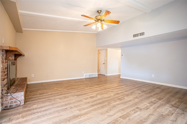 unfurnished living room featuring a fireplace, light hardwood / wood-style floors, ornamental molding, and ceiling fan