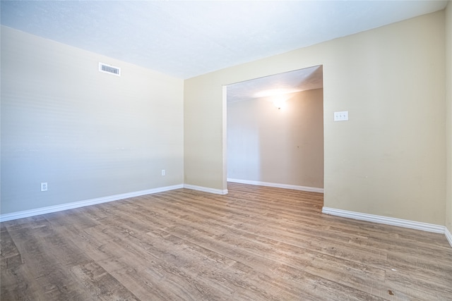 unfurnished room with light hardwood / wood-style floors