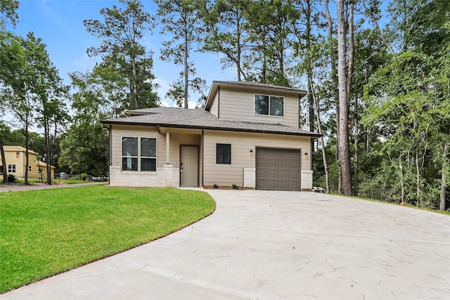 view of front of property featuring a front yard and a garage