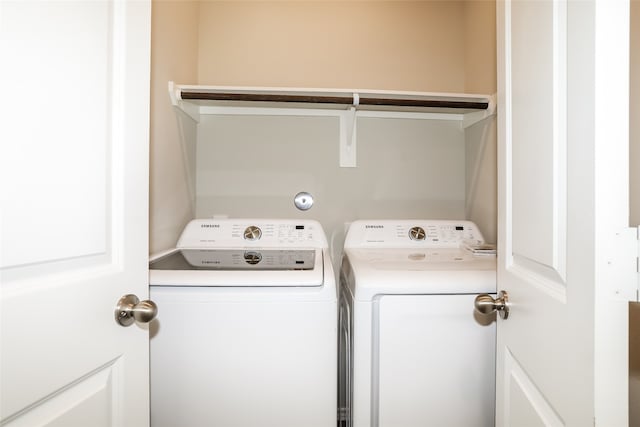 clothes washing area featuring independent washer and dryer