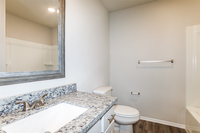 bathroom featuring hardwood / wood-style flooring, vanity, and toilet