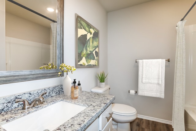 full bathroom with hardwood / wood-style floors, shower / bath combo, toilet, and vanity