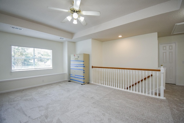 unfurnished room featuring ceiling fan and light colored carpet