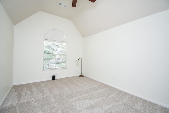 carpeted empty room featuring ceiling fan and vaulted ceiling