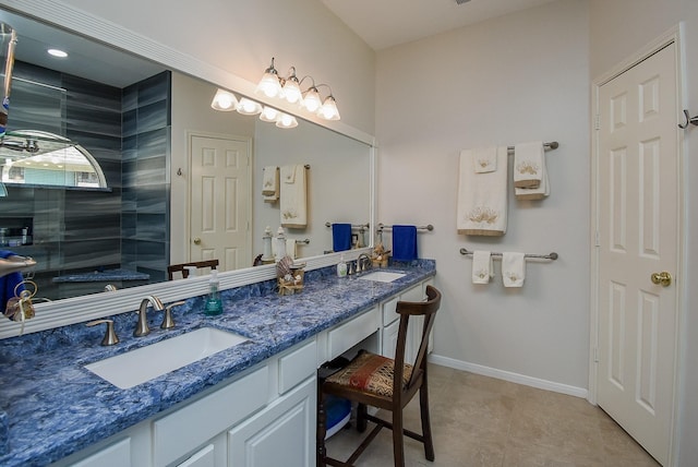 bathroom featuring tile patterned flooring, vanity, and walk in shower