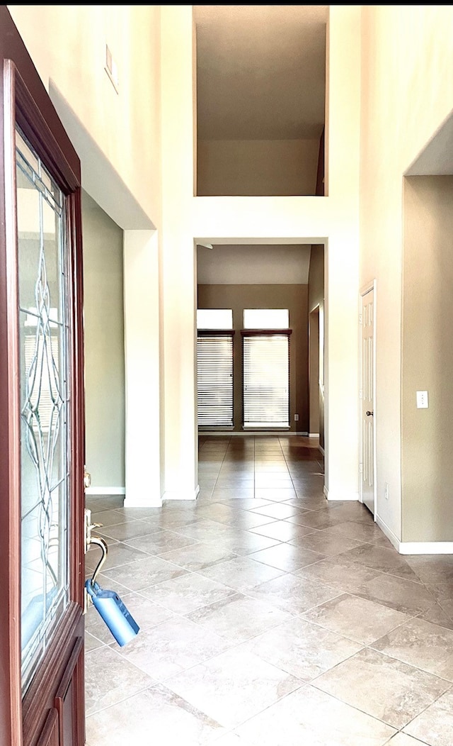 foyer entrance featuring a towering ceiling