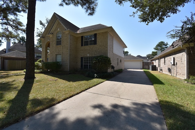 view of front of property featuring a front lawn, central AC unit, an outdoor structure, and a garage