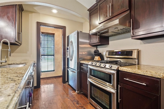 kitchen featuring sink, range with two ovens, dark hardwood / wood-style floors, and light stone countertops