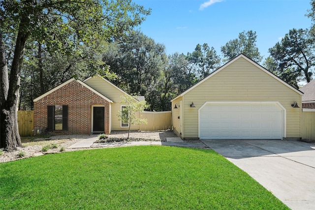 view of front of house with a front yard and a garage