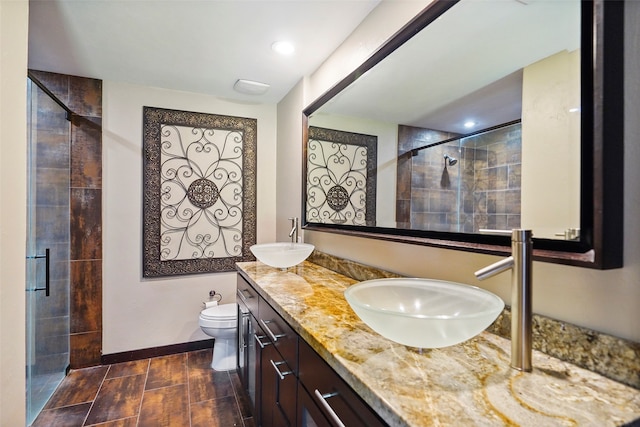 bathroom with an enclosed shower, vanity, and toilet