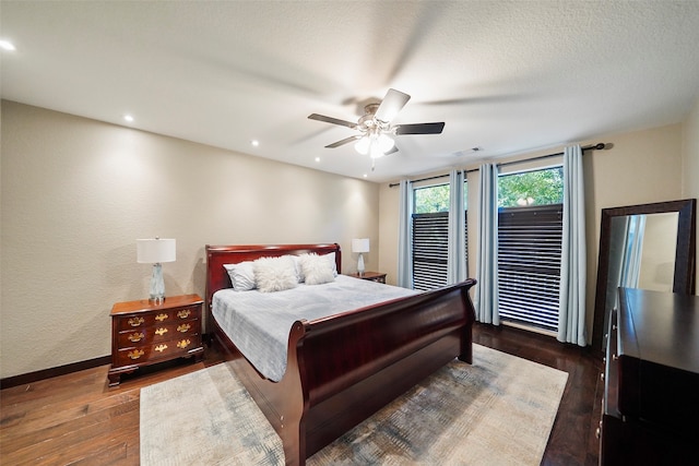 bedroom with ceiling fan and dark hardwood / wood-style floors