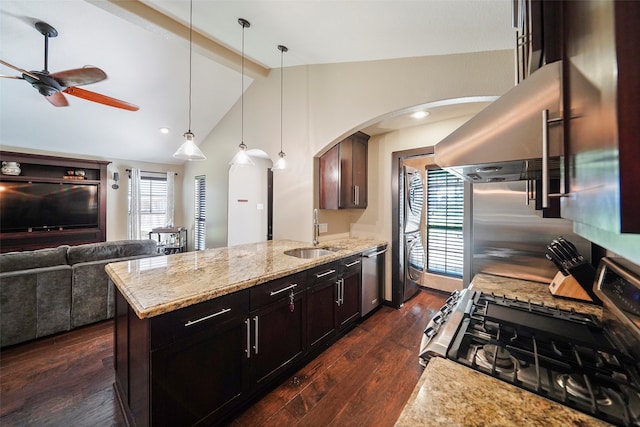 kitchen with dark brown cabinetry, dark wood-type flooring, sink, appliances with stainless steel finishes, and decorative light fixtures