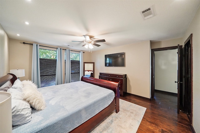 bedroom with dark wood-type flooring and ceiling fan