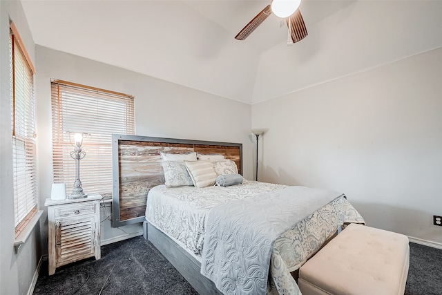 bedroom featuring dark colored carpet, ceiling fan, and vaulted ceiling