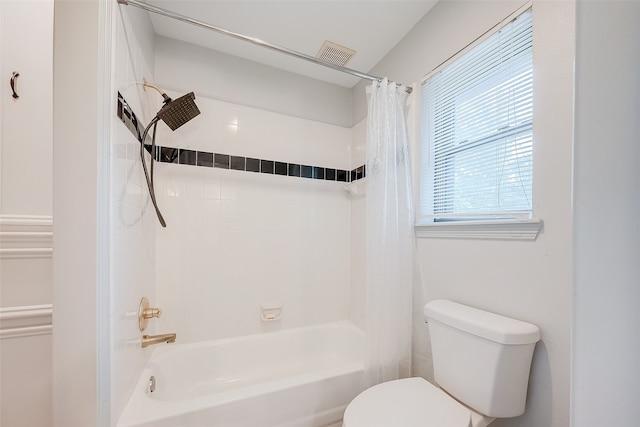 bathroom featuring shower / tub combo with curtain and toilet