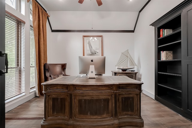 office with ceiling fan, ornamental molding, lofted ceiling, and light hardwood / wood-style floors