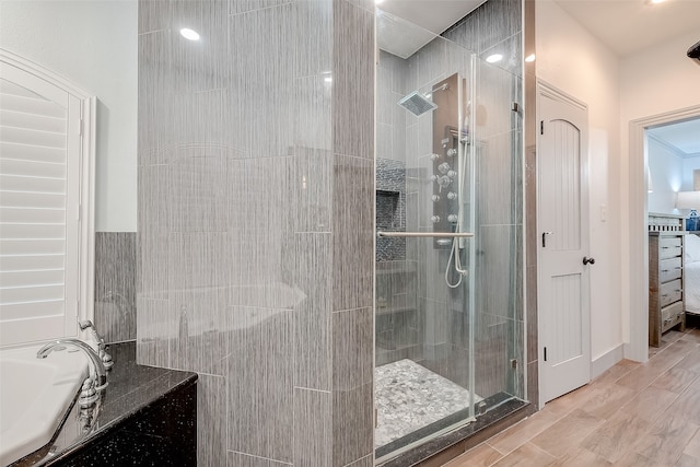 bathroom featuring hardwood / wood-style floors and plus walk in shower