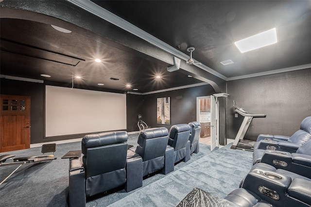 carpeted home theater featuring crown molding