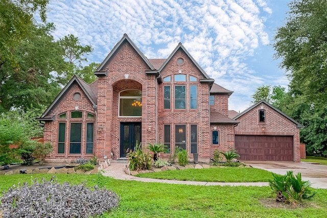 view of front of property featuring a front lawn and a garage