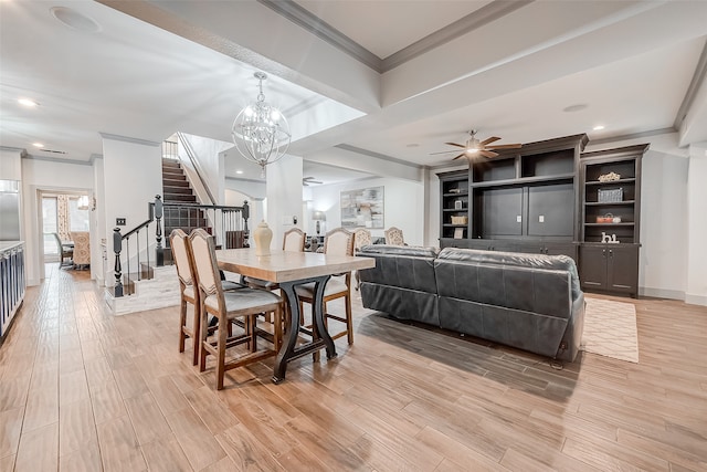 dining room featuring ceiling fan with notable chandelier, crown molding, and light hardwood / wood-style flooring