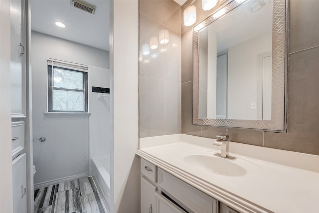 bathroom featuring hardwood / wood-style flooring, vanity, and toilet