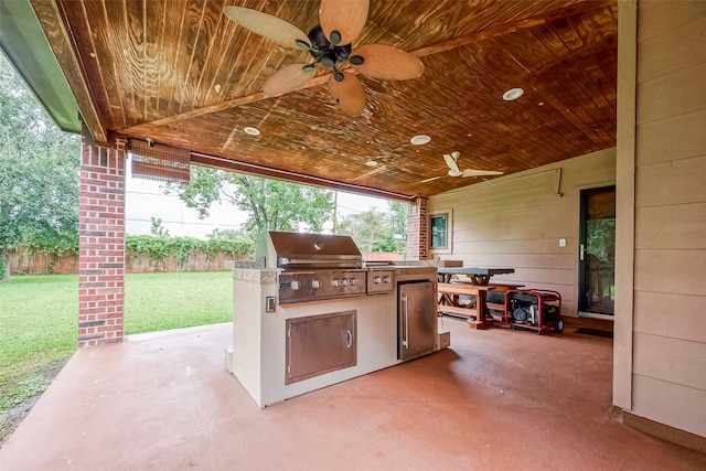 view of patio featuring ceiling fan, grilling area, and exterior kitchen