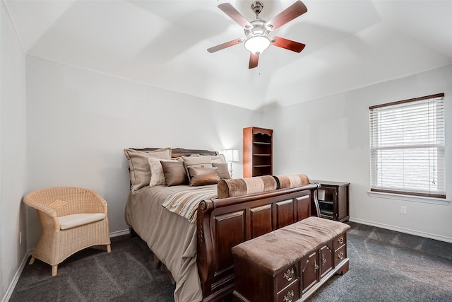 bedroom featuring lofted ceiling, dark carpet, and ceiling fan