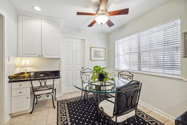 tiled dining area featuring ceiling fan