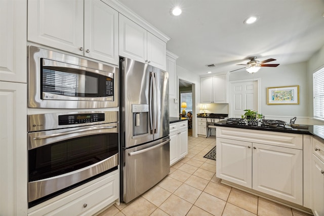 kitchen with white cabinetry, ceiling fan, light tile patterned floors, and appliances with stainless steel finishes