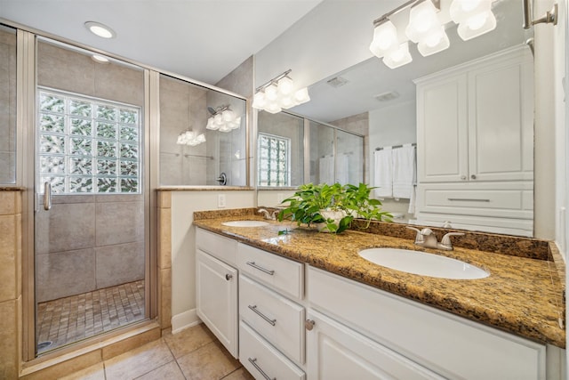 bathroom featuring vanity, walk in shower, and tile patterned floors