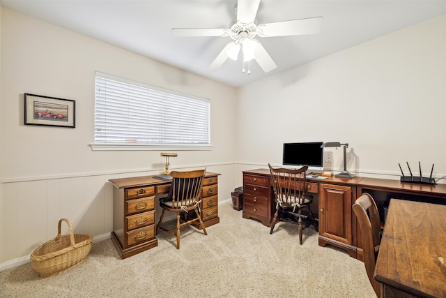 carpeted office space with ceiling fan