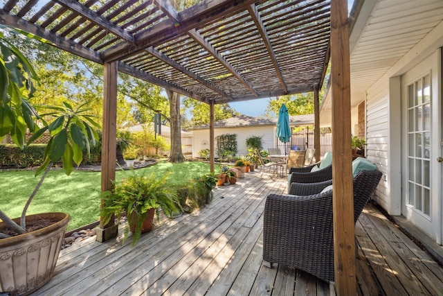 deck featuring a pergola and a lawn