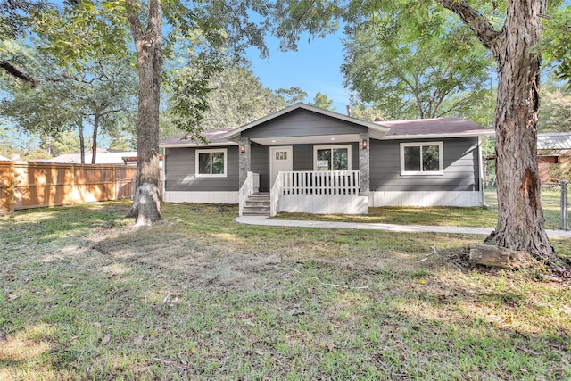 ranch-style house featuring a front yard and a porch