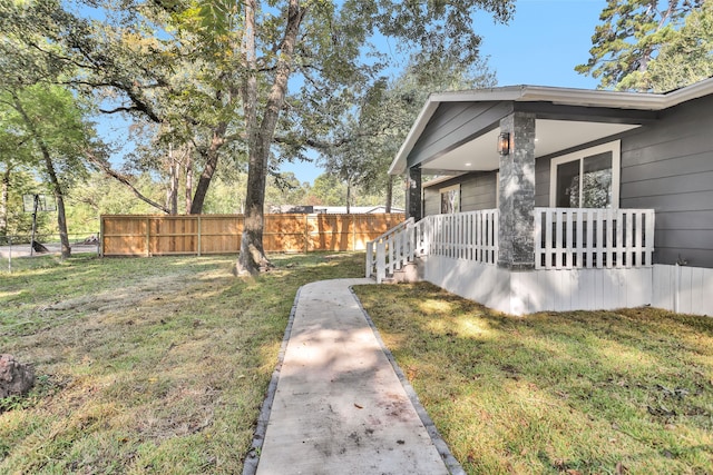 view of yard featuring covered porch