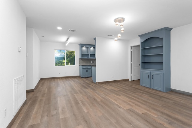 unfurnished living room with hardwood / wood-style flooring